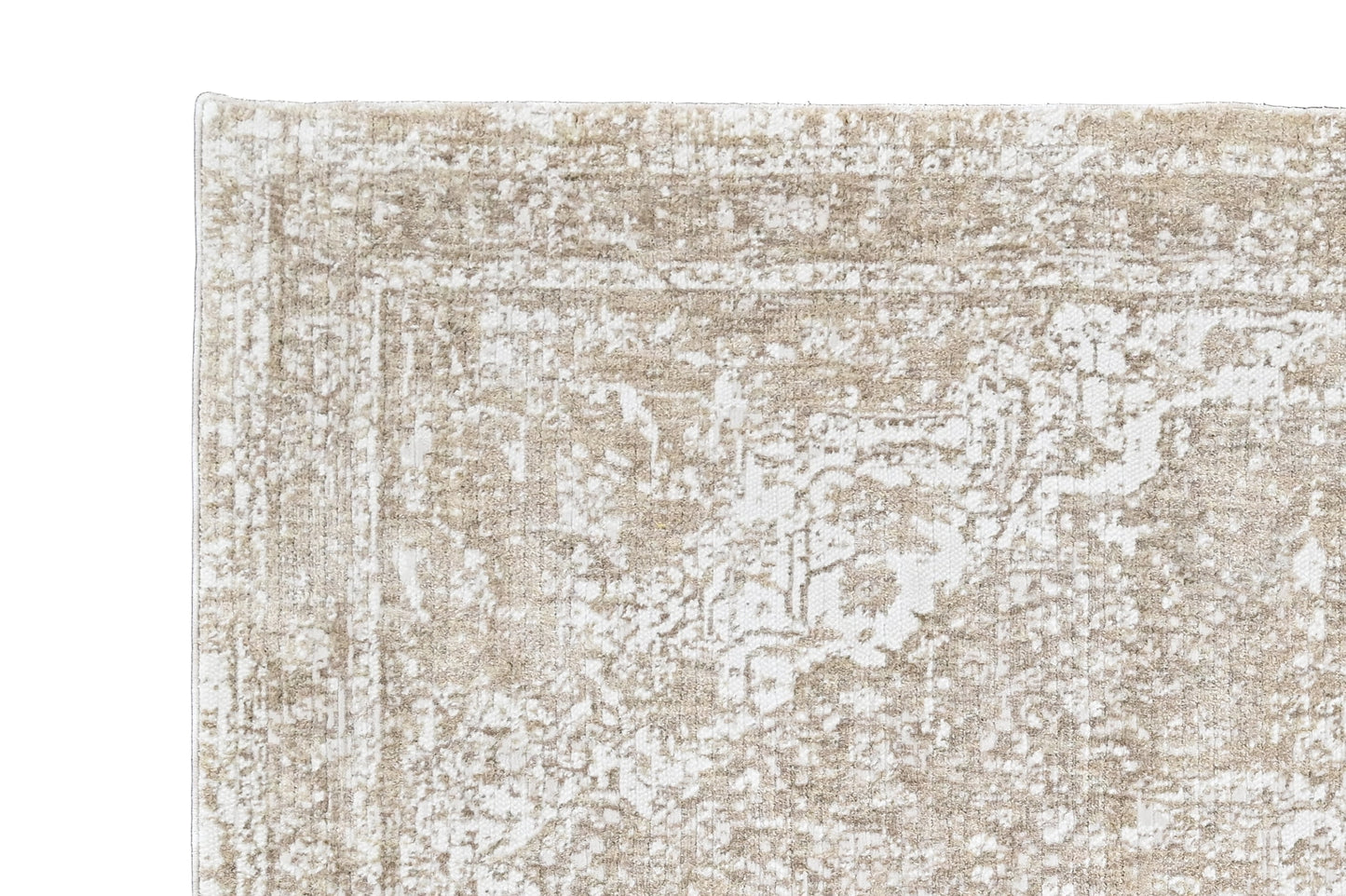 Beige and white patterned rug on a black background